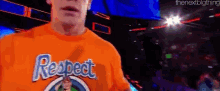 a man wearing an orange shirt that says respect