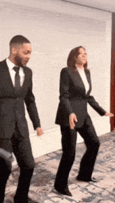 a man and a woman are dancing together in a room .
