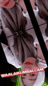 a woman wearing a hijab is reflected in a mirror with the words waalaikumsallam on the bottom