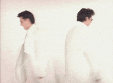a blurry picture of two men in white coats