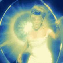 a woman in a white dress is surrounded by a blue and yellow background