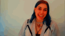 a woman with blue hair has a necklace that says annie