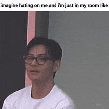 a man wearing glasses and a white shirt is making a funny face