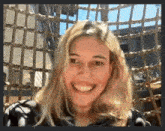 a woman is smiling while sitting in a chair