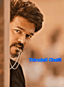a picture of a man with a necklace around his neck and the words thiruda n chat