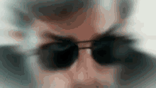 a blurry image of a person wearing sunglasses