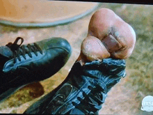 a close up of a person 's foot in a pair of black shoes .