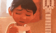 a close up of a cartoon character holding a piece of paper in his hand .