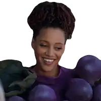 a woman in a purple shirt is smiling while holding purple onions