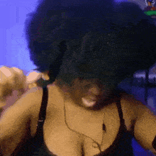 a blurry picture of a woman with a big afro