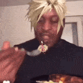 a man is eating a spoonful of food with a picture of a cartoon character on his face .