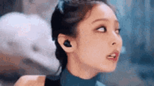 a close up of a woman wearing headphones and looking up .