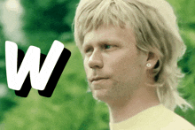 a man with a mullet and a letter w on the bottom
