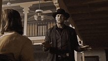 a man in a cowboy hat is talking to a woman and the words but he was a disagreeable