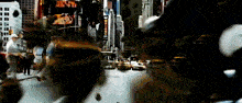 a blurry picture of a city street with a sign that says ' times square '
