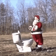 a santa claus statue is standing on a toilet in a field .