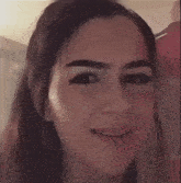 a close up of a woman 's face with a slight smile on it .