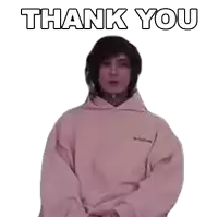 a man wearing a pink hoodie is giving a thank you gesture .