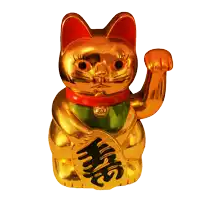 a golden statue of a cat with a red bow around its neck