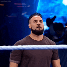 a man with a beard is standing in a wrestling ring with bestofguerrillas written on the bottom