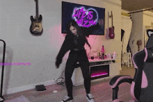 a woman is dancing in a living room in front of a tv that says life is jazz .