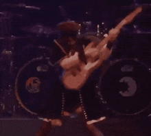 a woman in a maid dress is playing a guitar on a stage .