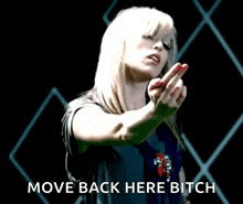a woman giving the middle finger with the words move back here bitch below
