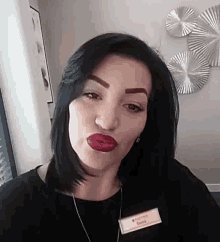a woman with red lipstick is making a funny face .