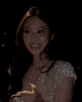 a woman in a white dress with pearls on the shoulder