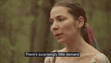 a woman is standing in the woods with a caption that says there 's surprisingly little demand