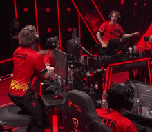 a man wearing headphones and a red shirt that says sg