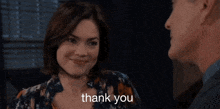 a man and woman are looking at each other and the woman is saying thank you