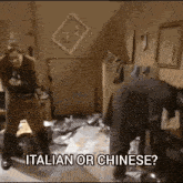 a man and a woman are standing in a messy room with the words italian or chinese written on the bottom .