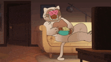 a cat wearing a mask is sitting on a couch eating popcorn
