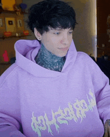 a person wearing a purple hoodie that says ' apocalypse ' on the front