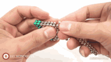 a person is holding a bunch of beads and the words diy wonderful are on the bottom right
