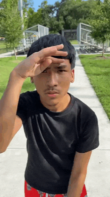 a young man covering his eyes with his hand