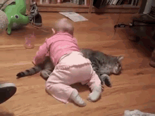Baby Girl Hugs Her Kitty GIF