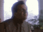 a blurry picture of a man 's face with his eyes closed