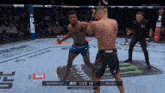 two men are fighting in a ufc ring with a monster energy logo on the ground