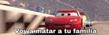 lightning mcqueen from cars is driving down a race track with other cars and says `` voy a matar a tu familia '' .