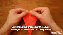 a person is holding a piece of paper that says just make the creases of the square stronger