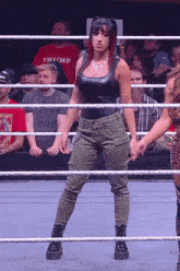 a woman in a wrestling ring is wearing a shirt that says thump