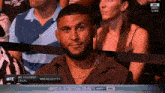 a man with a beard is sitting in the audience watching a ufc fight