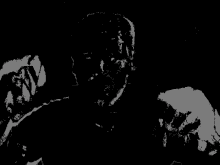 a black and white image of a man 's face with a few white spots on it