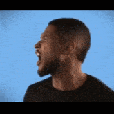 a man in a black shirt is screaming with his mouth wide open