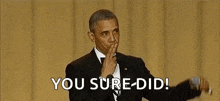 barack obama is holding a microphone in his hand and saying `` you sure did '' .