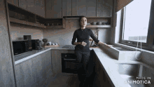 a woman standing in a kitchen with the words made in animatica on the bottom right
