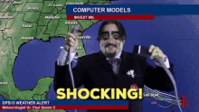 a man in a suit and tie is holding a hose in front of a map that says computer models