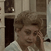 a woman with blonde hair is sitting in front of a door